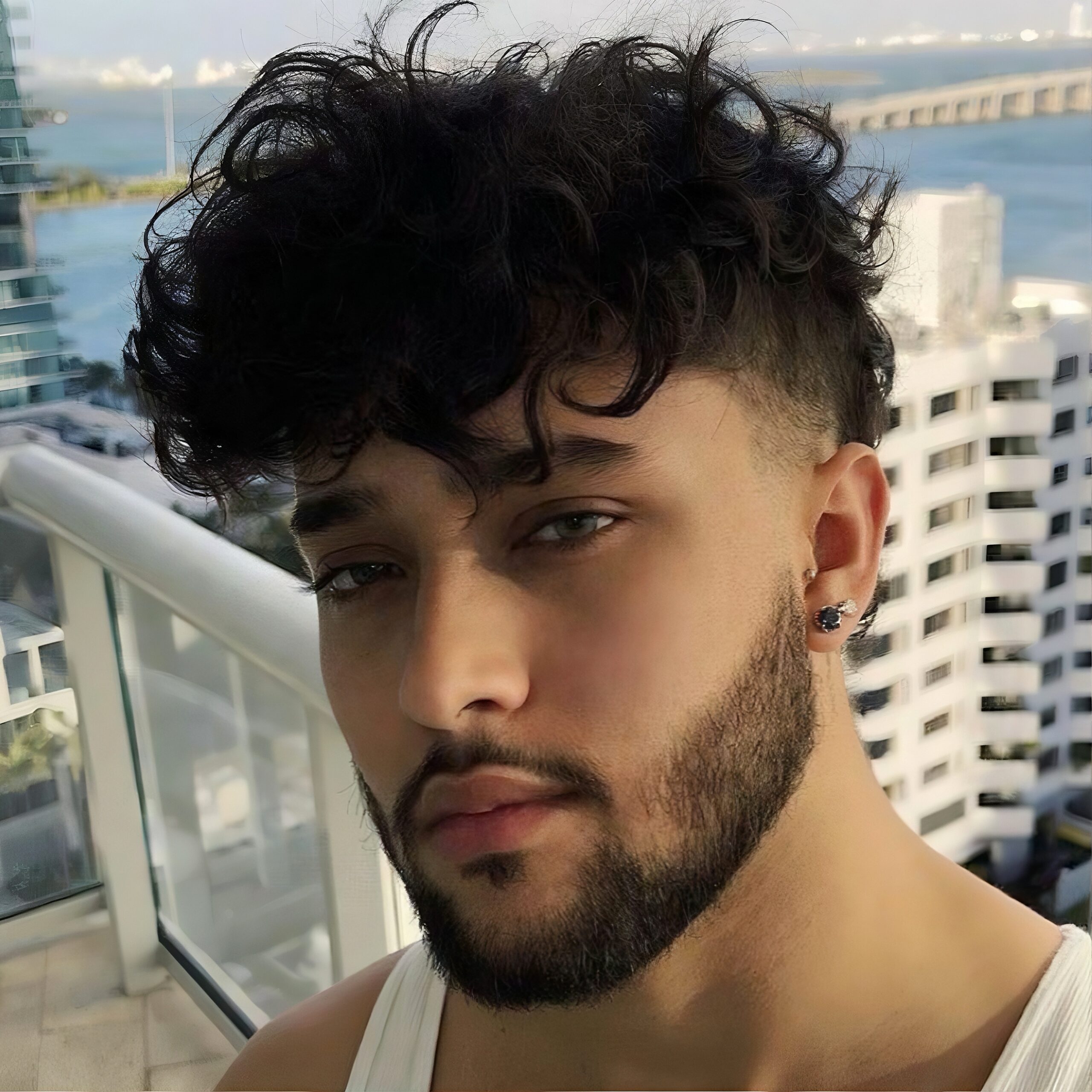 Textured modern mullet hairstyle for men with messy volume